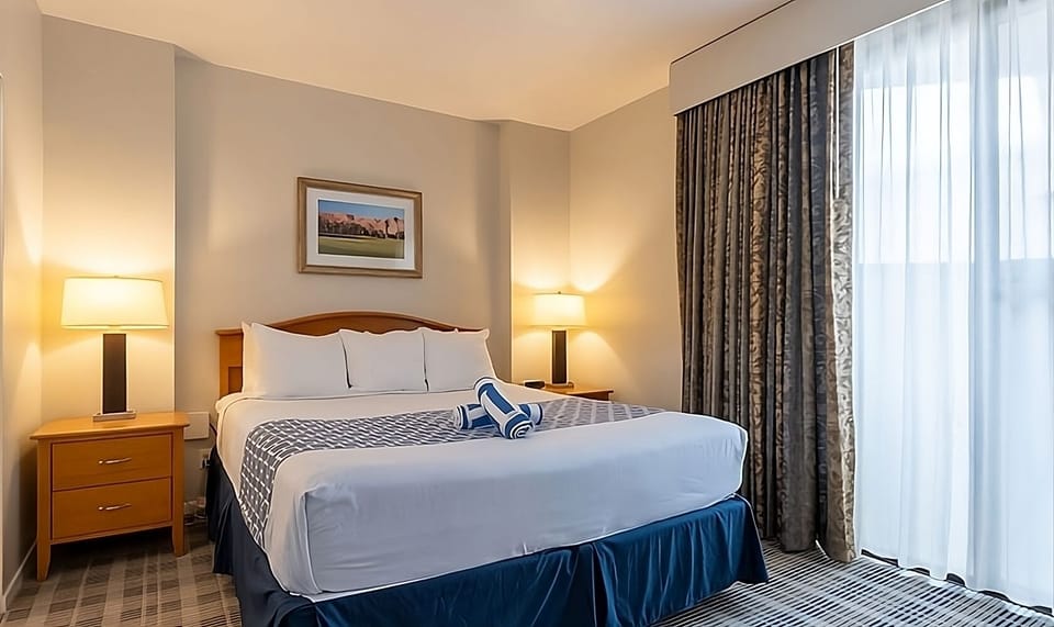 Unwind in a bright king bed with soft, hotel-style linens.