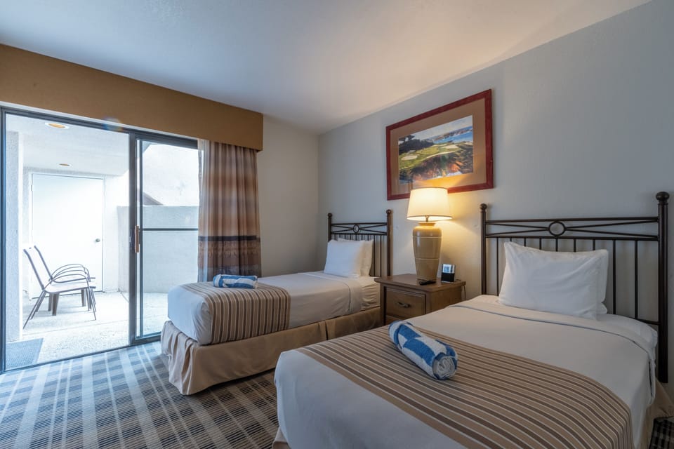 Step onto the balcony after a restful night in twin beds.