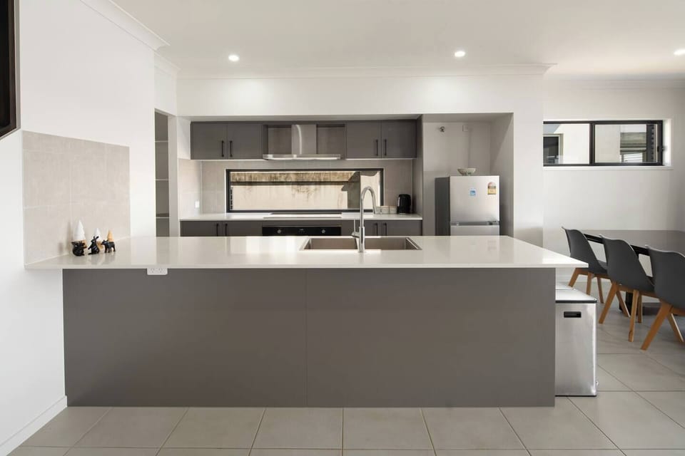 The kitchen’s oversized island bench doubles as a gathering point for casual chats while preparing meals.
