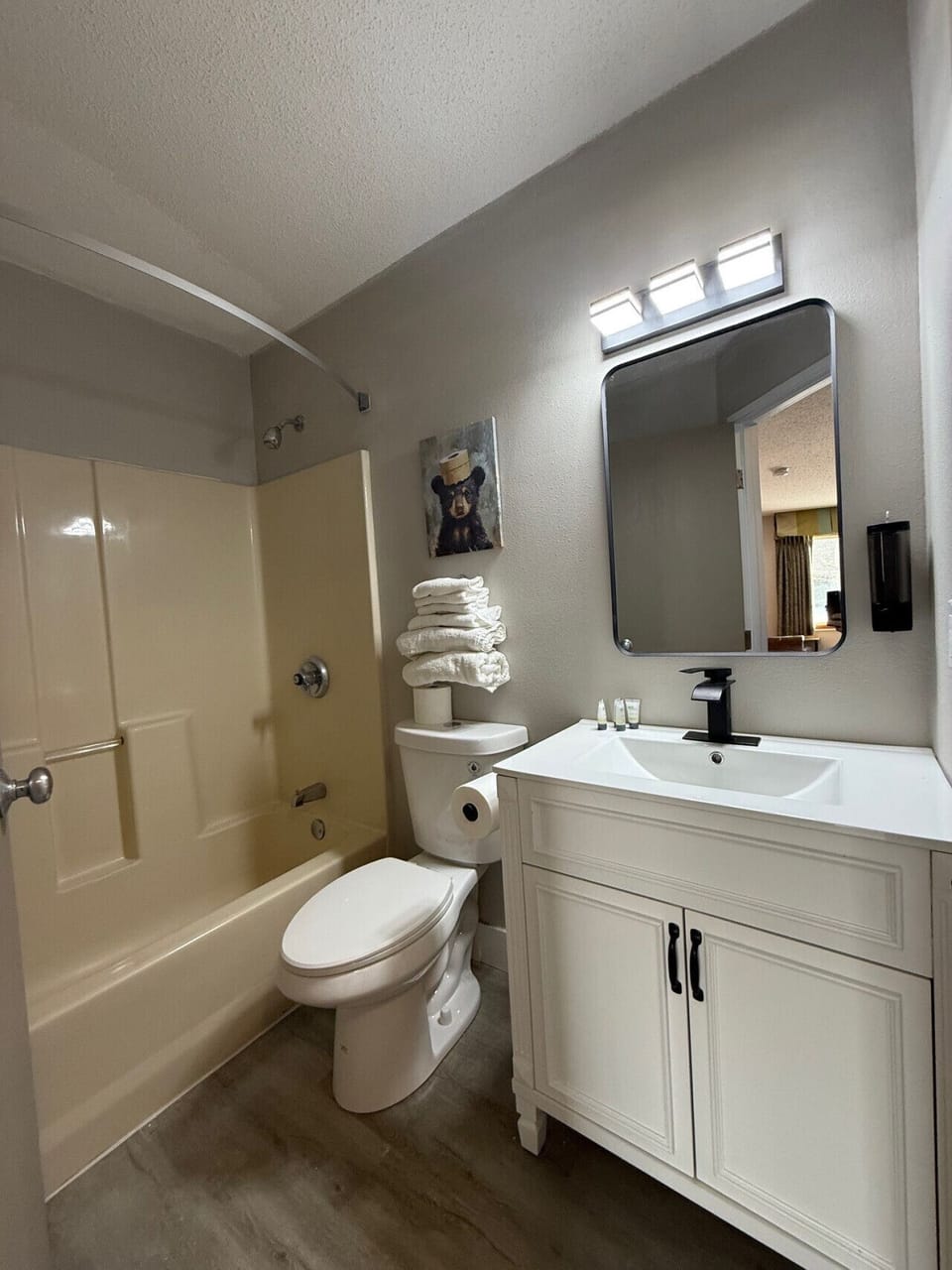 Modern bathroom offering a glass-mirrored vanity and fresh linens