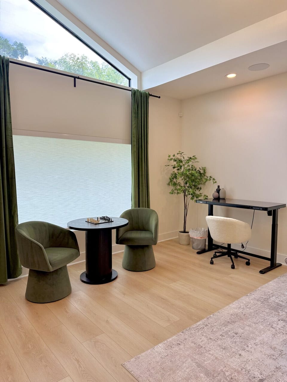 Bright and airy sitting nook with cozy chairs for games or conversation, plus a desk for work or study