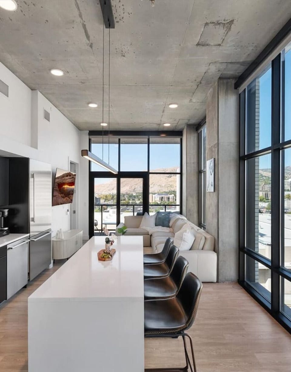 Beautifully designed living area. 65`TV, Gas Fireplace, Spacious Comfy Leather Couch with views of the Delta Center/The Jazz Arena off the deck.