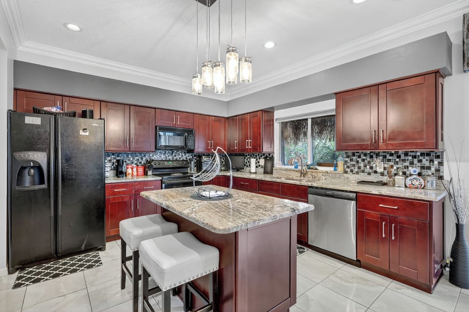 Fully-equipped kitchen with granite counters and center island.