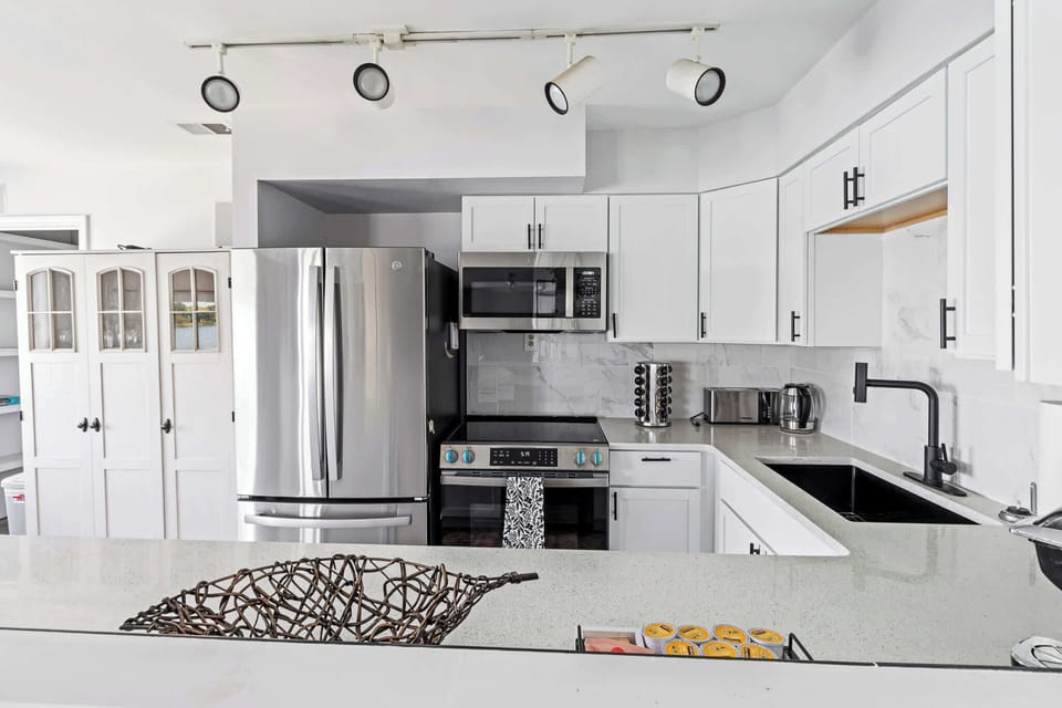 Clean, open kitchen w/ modern finishes, ready for everything from snacks to full meals.