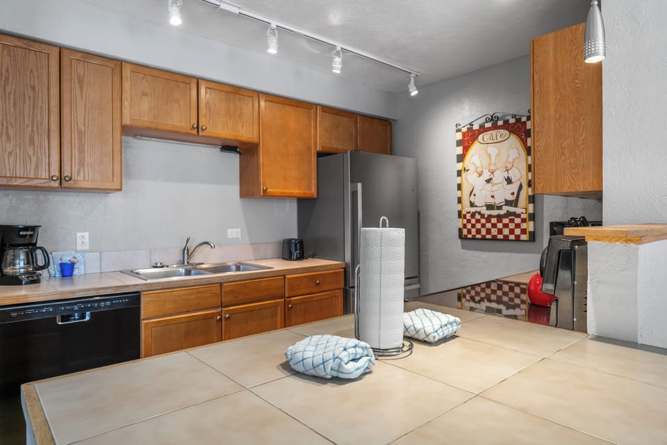 Your fully equipped kitchen awaits with warm wood cabinetry, modern appliances, and plenty of space to prepare memorable meals during your stay.