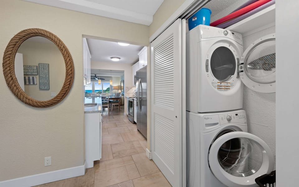 Stacked washer and dryer just off the foyer.