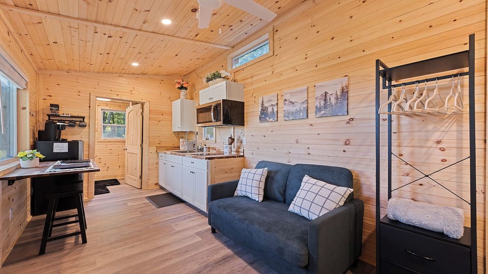 Bright tiny home with full kitchen, sofa, and workspace for meals or remote work