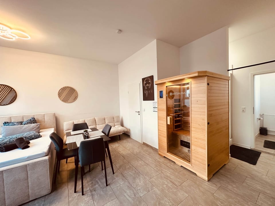 Living and sleeping area with sauna, dining area and comfortable sofa bed