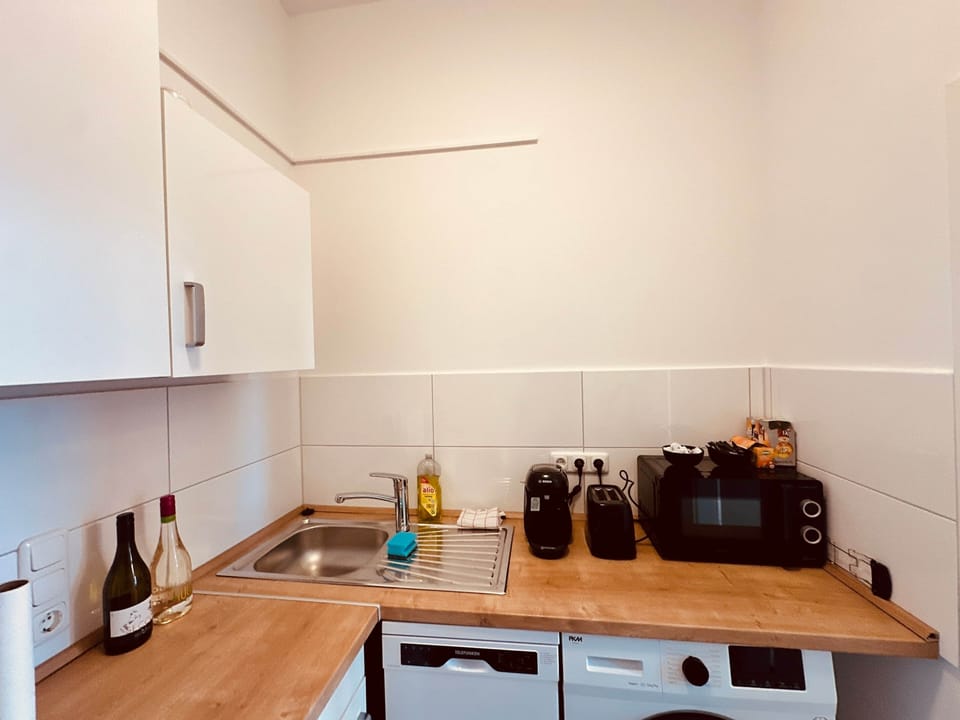 Kitchen with sink, appliances and additional storage space