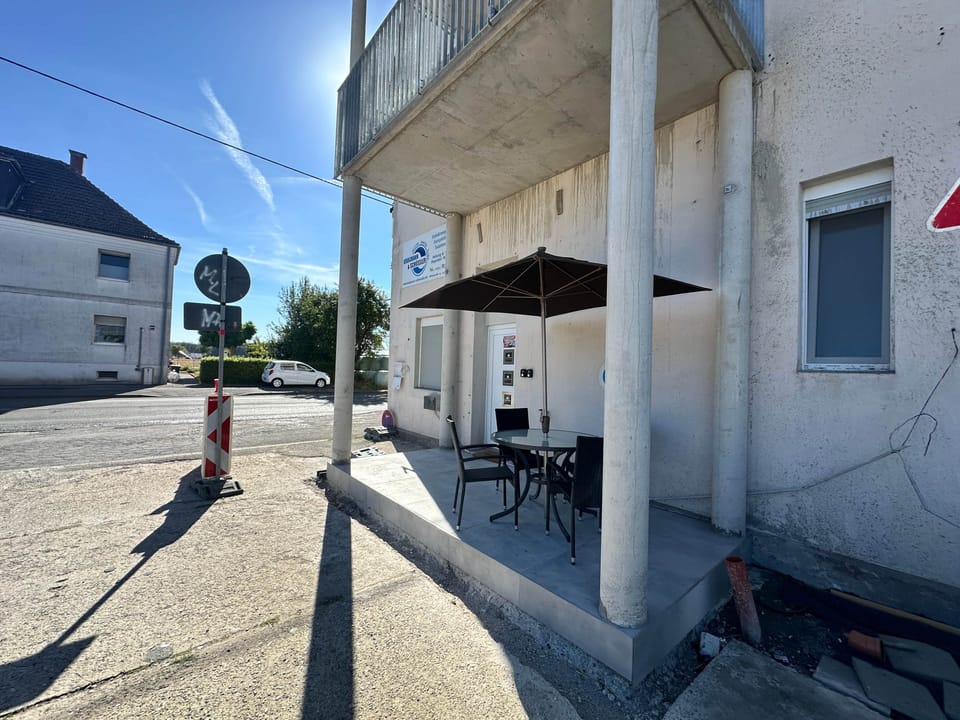 Private covered seating area and entrance door to the apartment