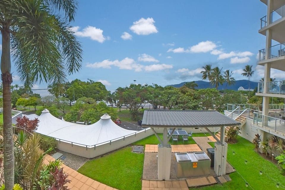 Enjoy alfresco meals in the shared backyard BBQ area, featuring comfortable seating and a peaceful setting. Ideal for relaxing afternoons or evening cookouts after a day exploring Cairns' attractions and beautiful coastline.