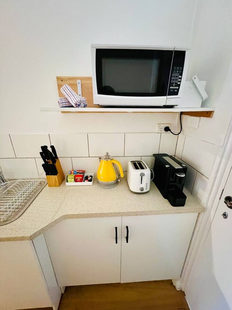 The unit features a full kitchen with modern appliances including a stove, oven, microwave, and fridge. It offers ample counter space and comes fully equipped with cookware and utensils, making it easy and convenient to prepare meals during your stay