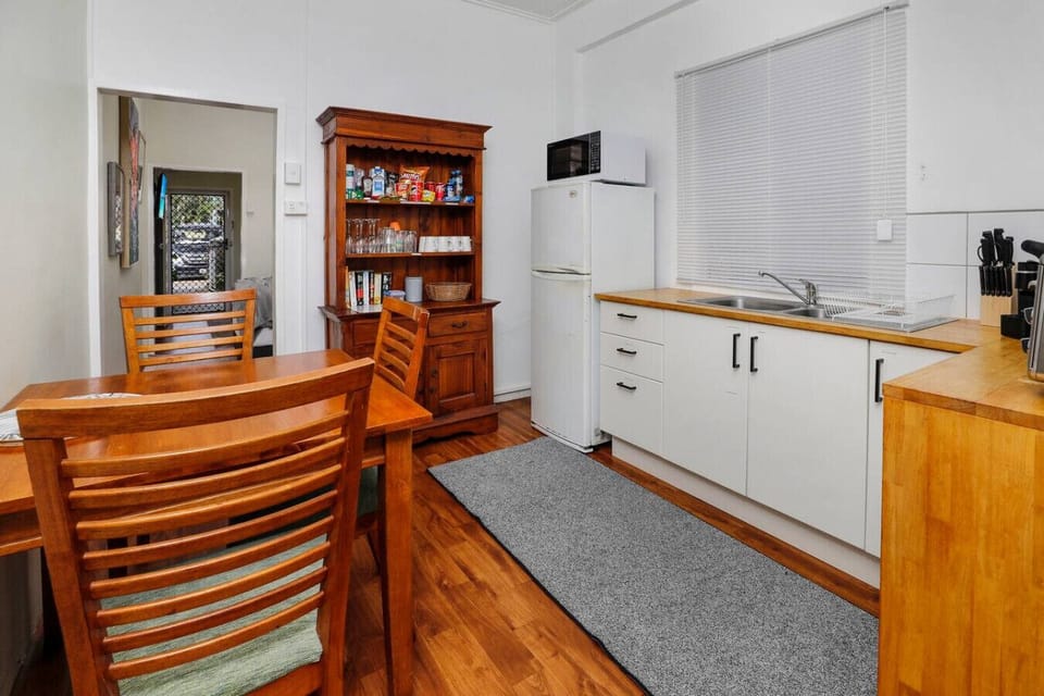 Cozy dining area with a stylish table and comfortable seating for four. Perfect for enjoying meals, morning coffee, or evening chats in a bright and inviting space.