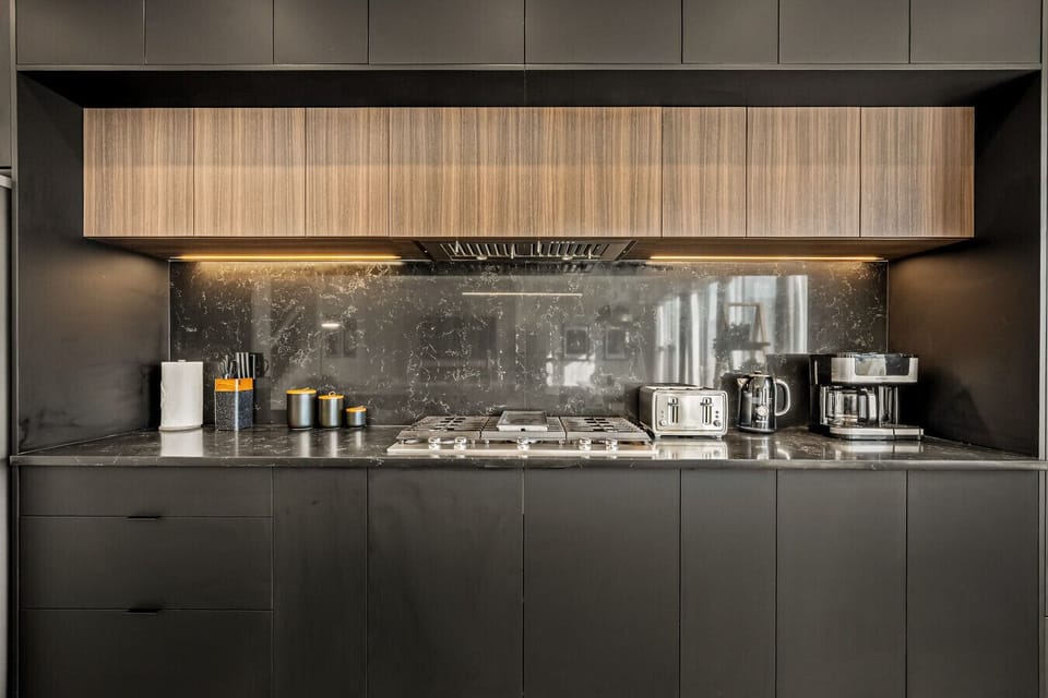 Well-equipped kitchen with gas range, marble counters, and modern appliances
