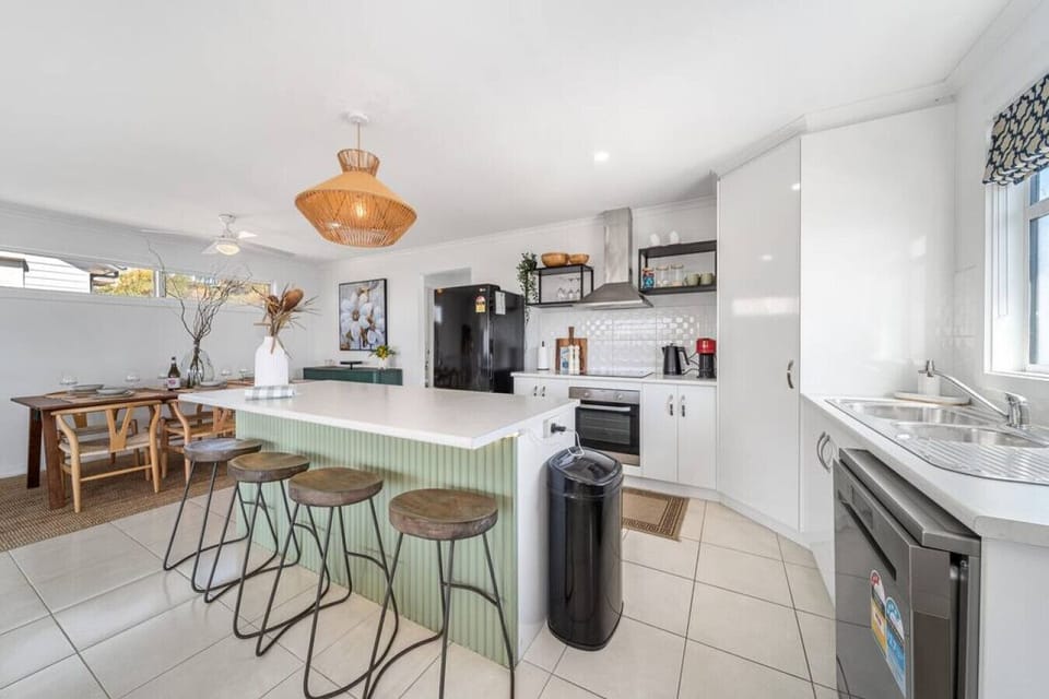 The spacious kitchen bench invites conversation as meals are prepared and plans for the day unfold.