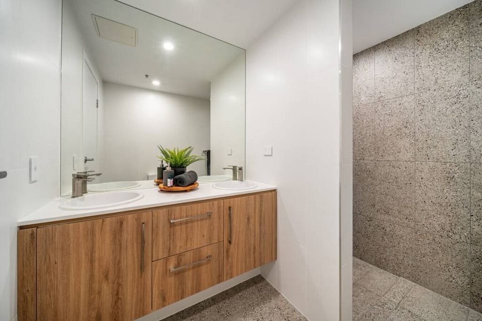 Refresh in the designer ensuite with dual sinks and an open shower that feels bright and spacious.