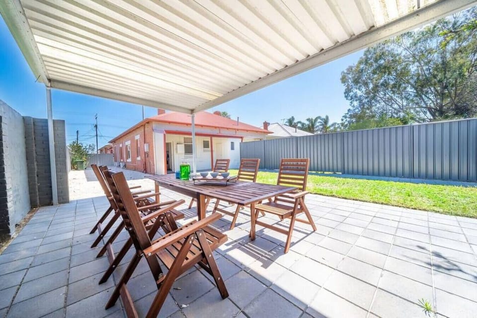 Dine outdoors on the covered patio where the six-seat table invites long lunches and relaxed evenings in the fresh air.