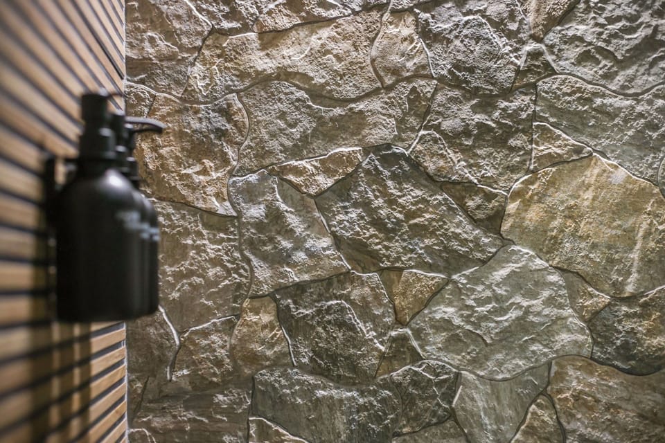 Indulge in a spa-like shower surrounded by natural light and earthy touches for the ultimate retreat.