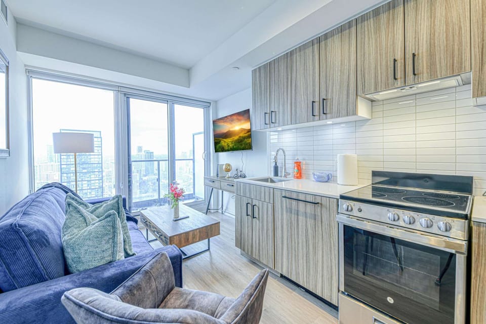 A bright living space with a balcony for a breath of fresh air.