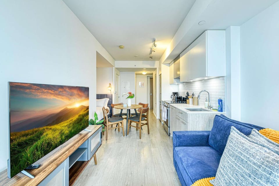 Modern and clean living space with a dining area for four.