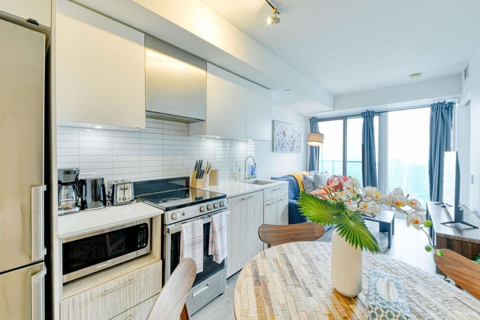 The apartment's kitchen features modern appliances and a clean, minimalist design.