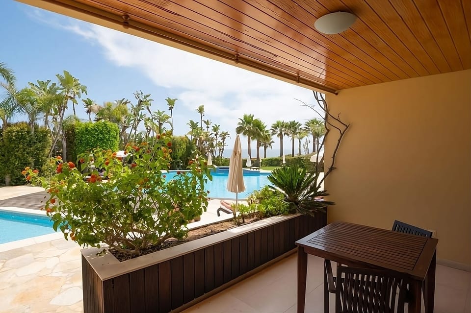 Sip morning coffee on your shaded terrace beside the pool.