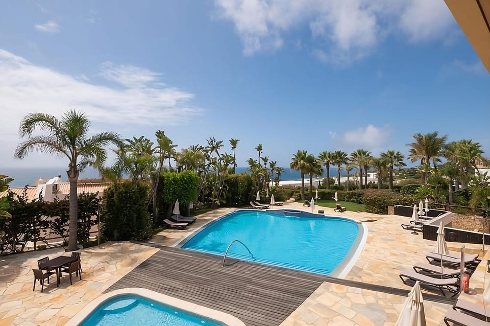 Dive into sunlit serenity with ocean views and palms.