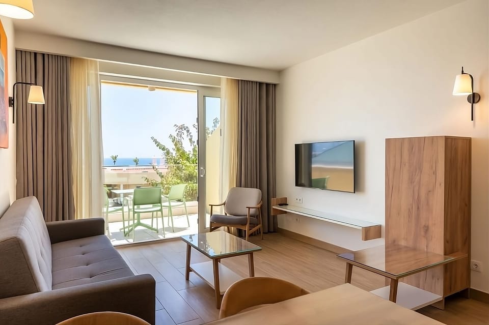 Sip morning coffee while sunlight pours through terrace doors.