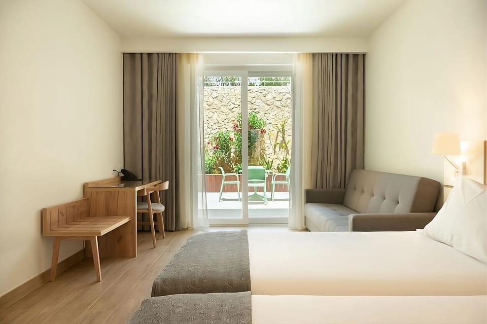 Stretch out with sofa seating and breezy balcony doors.