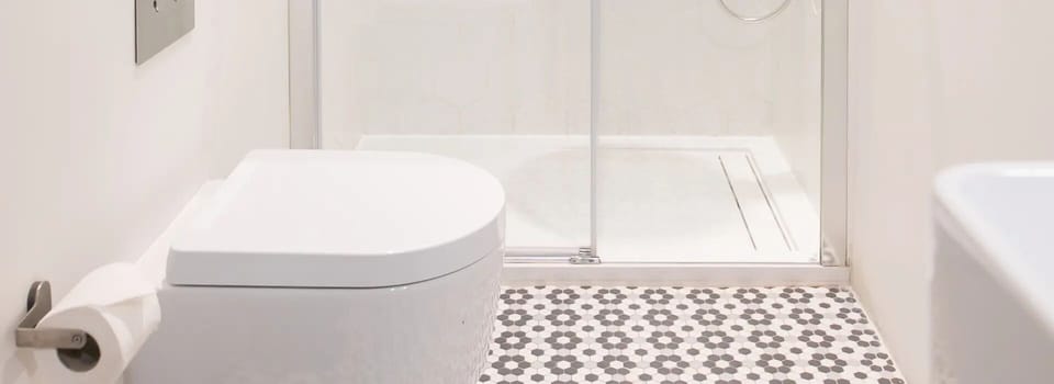 Rinse off in a sleek walk-in shower with patterned tile.