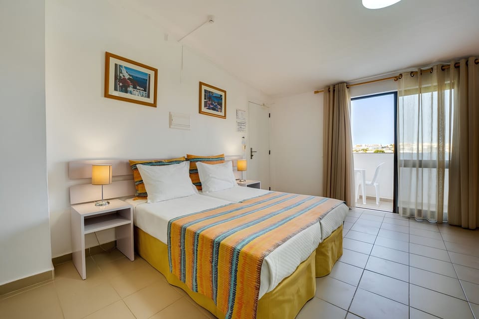 Unwind in crisp linens with sunshine and balcony views.