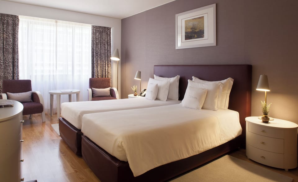 Unwind in crisp linens and soft lighting after adventures.