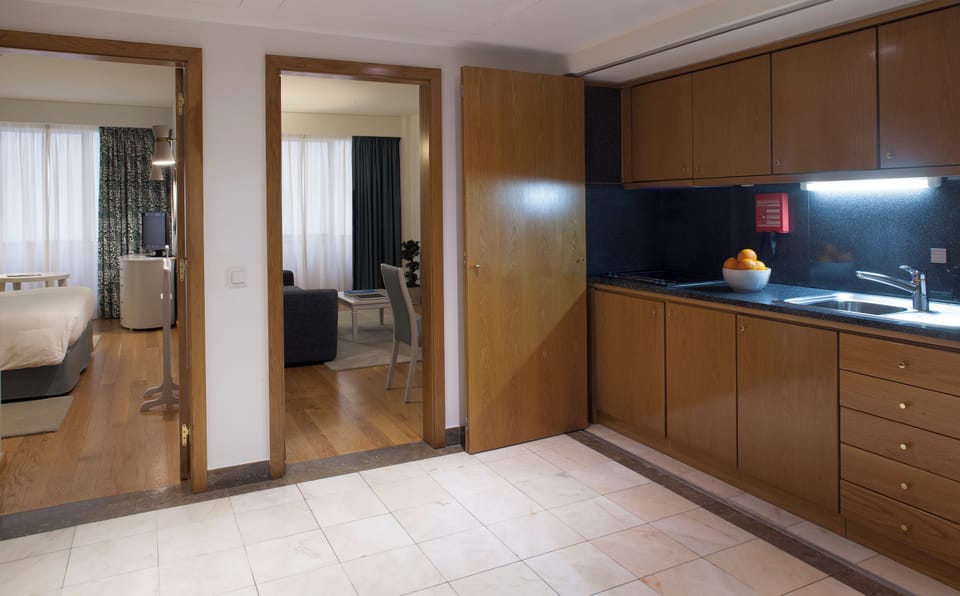 Step into your suite with kitchenette and cozy bedroom beyond.