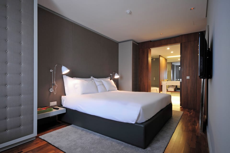 Stretch out on fresh white linens in a minimalist retreat.