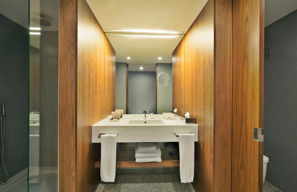 Unwind in a spa-like bathroom with warm wood serenity.