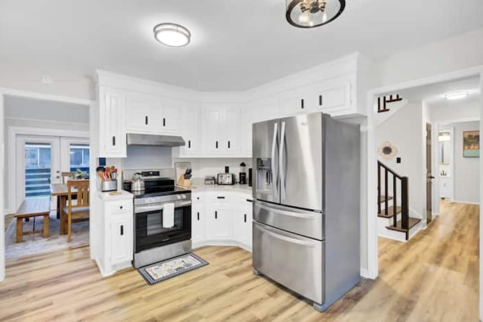 Bright, fully equipped kitchen with stainless appliances and ample space.