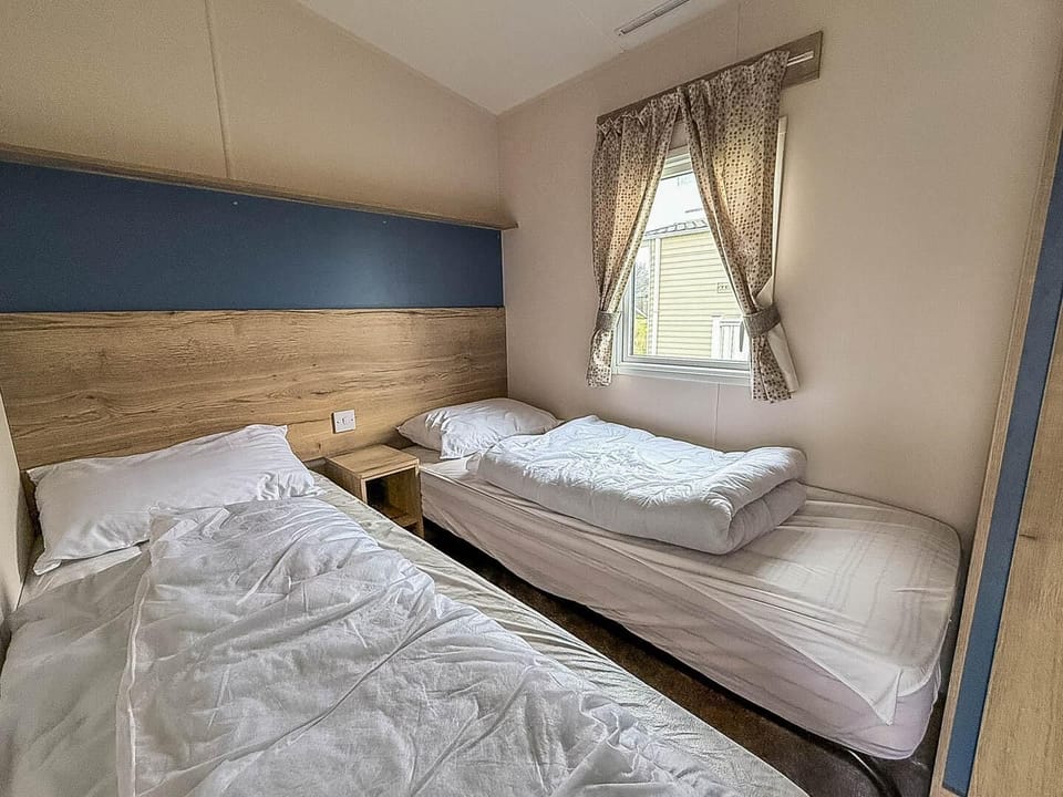 Practical twin caravan bedroom, designed to offer comfort and functionality for your UK travels!