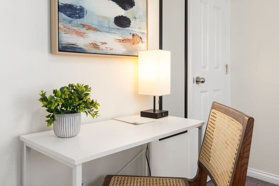 Dedicated workspace with desk, chair, and task lighting.