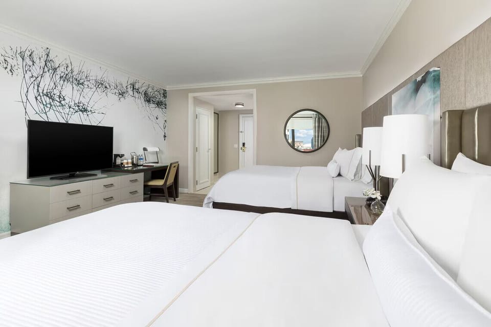 Unwind in a spacious double-queen room with calming décor.