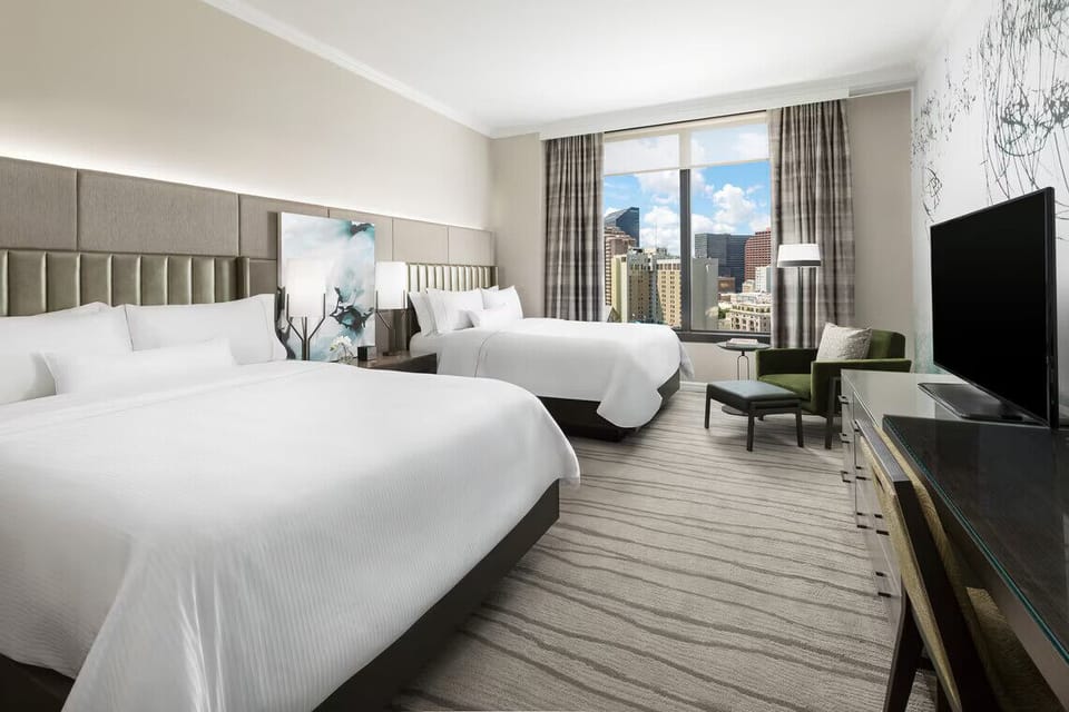 Stretch out together in a sunlit double-queen retreat.