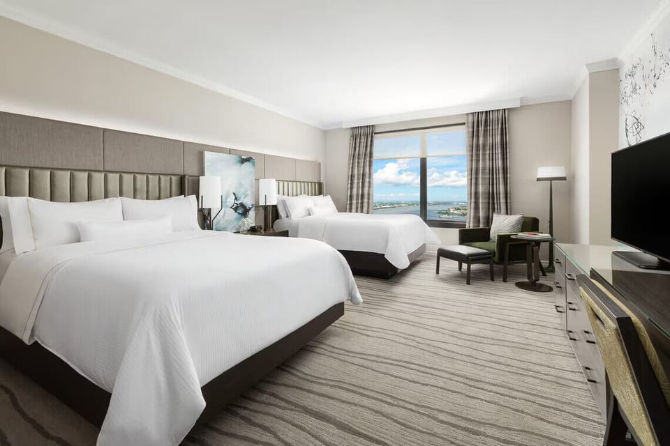 Unwind in airy double-queen comfort with sweeping skyline views.