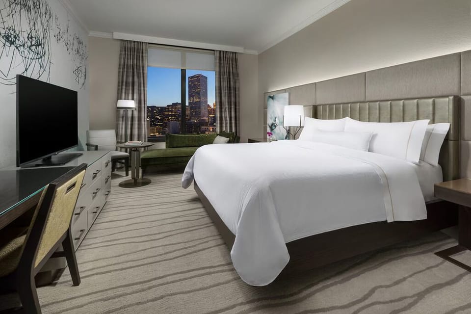Recharge in a serene bedroom framed by skyline windows.