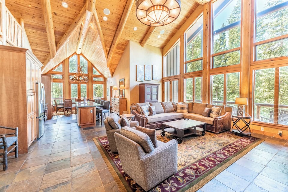 Main living area features ample seating, main balcony access, and flatscreen TV