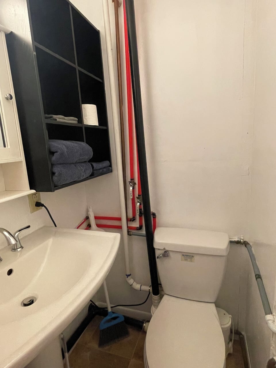 Toilet, sink, medicine cabinet, towels, starter toilet paper supply. 