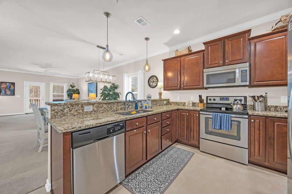 Fully equipped kitchen with stainless steel appliances.
