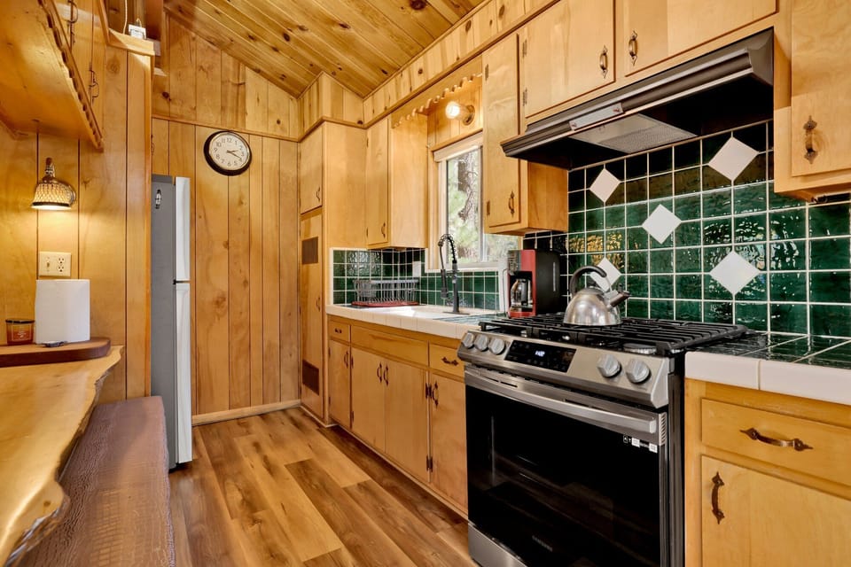 Fully equipped cabin kitchen with ample cabinetry, stove, fridge, and coffee maker—perfect for cooking meals, morning coffee, and feeling right at home on your stay.