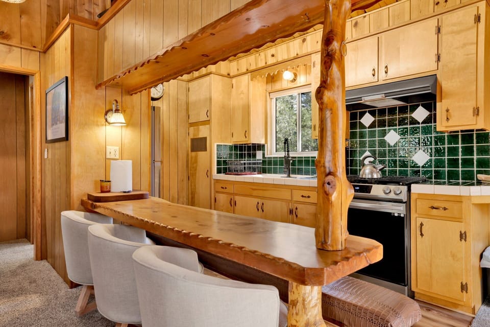 Fully equipped cabin kitchen with ample cabinetry, stove, fridge, and coffee maker—perfect for cooking meals, morning coffee, and feeling right at home on your stay.