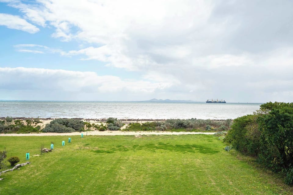 From the backyard, step directly into the shallow waters of the bay