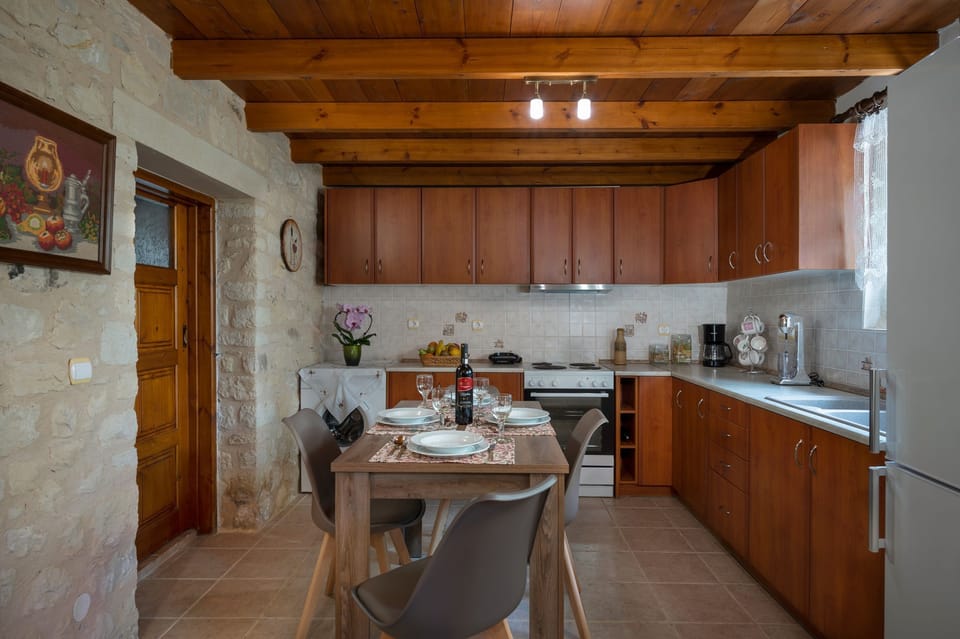 Our  kitchen adorned with wooden cupboards, fully equipped to cater to your culinary needs.