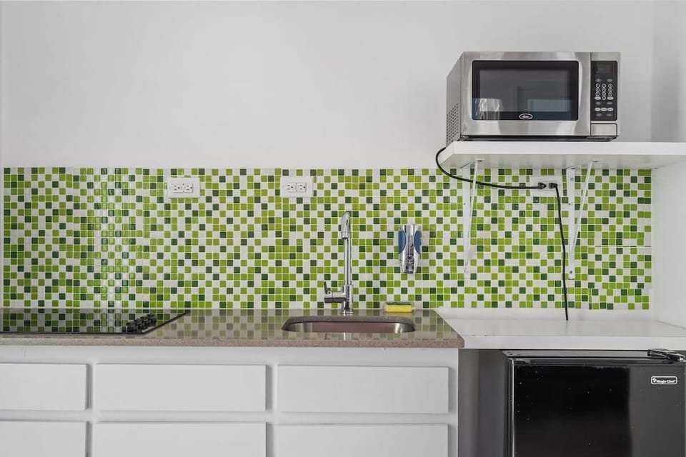 Prepare your favorite snacks in this well-equipped kitchen space with unique decorative tiles.